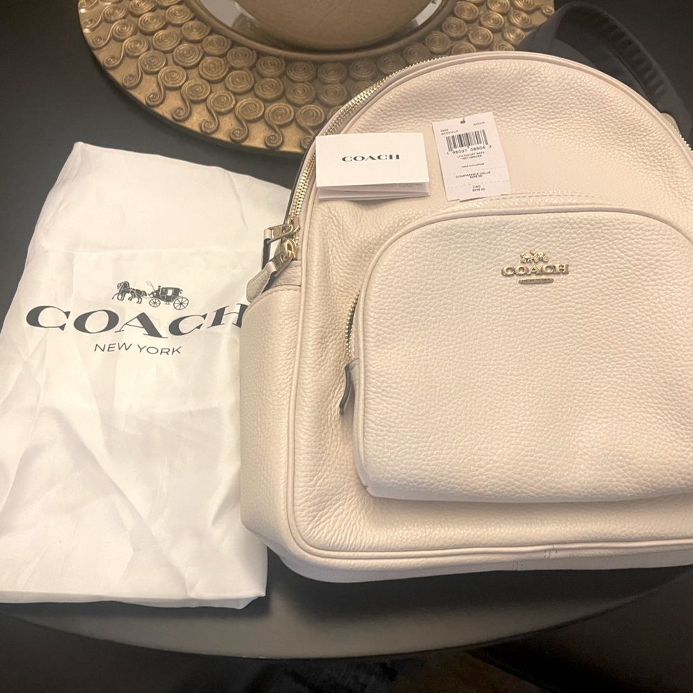 Coach backpack, cream with black back, excellent condition. Used only once.